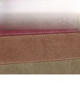 Detail of color-block canvas tote showing fine double-stitching in burgundy and olive