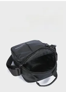 Detail of multi-pocket black oxford bag showing main compartment with internal zippered divider