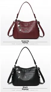 Detail view of burgundy and black pebbled leather bags with adjustable shoulder straps