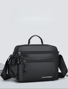Detail view of large waterproof men's shoulder bag featuring multi-zipper compartments