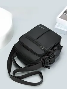 Close-up of durable black nylon crossbody bag with multi-layer zippers and side pockets