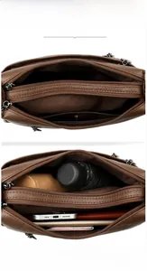 Detail view of the brown leather bag interior with multiple storage compartments
