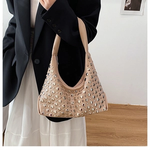 Detail showing apricot underarm bucket bag with silver rivet studs and zip closure