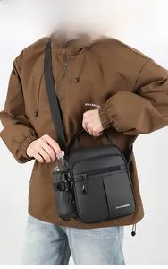 Detail view of black oxford crossbody bag featuring side water bottle holder and multi-pockets