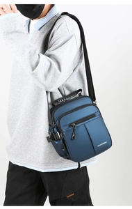 Detailed view of deep blue multi-pocket crossbody bag with durable oxford fabric texture