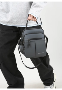 Detail view of multi-pocket dark grey Oxford shoulder bag with reinforced handles