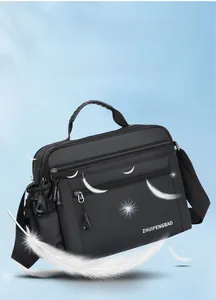 Lightweight black waterproof shoulder bag with multiple zippered compartments and feathers