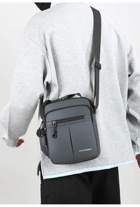 Detail view of the gray oxford crossbody bag showing the adjustable strap and back fit