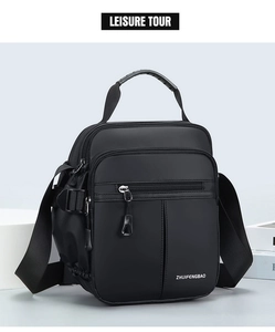Close-up of waterproof black oxford fabric and multi-zipper compartments on crossbody bag