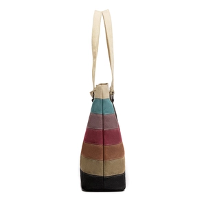 Striped canvas tote bag with multi-color patchwork panels and sturdy beige handles