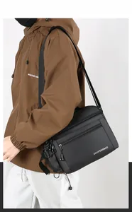 Macro detail of waterproof black nylon messenger bag with multiple zipper compartments