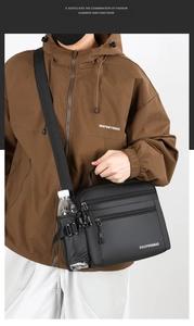 Detail view of water-resistant shoulder bag with multiple zip pockets and side bottle holder