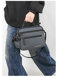 Detail showing grey waterproof nylon shoulder bag with side drawstring bottle pocket