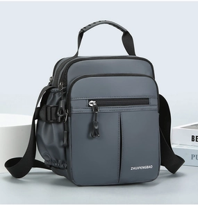 Detailed view of grey nylon multi-pocket messenger bag with adjustable strap and top handle