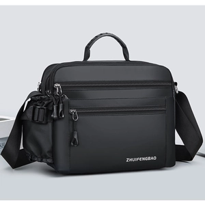 Close-up of waterproof nylon shoulder bag with triple zipper pockets and rubber handle