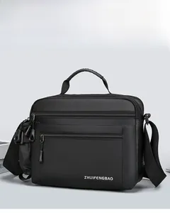 Close-up of waterproof black messenger bag with multi-layer zippers and top handle