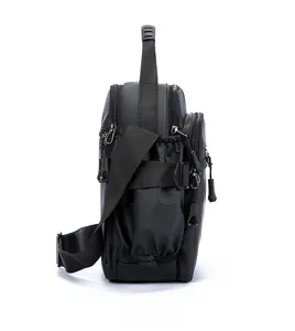 Side view of black multi-pocket oxford crossbody bag with adjustable wide fabric strap