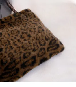 Close-up of leopard print plush tote bag showing premium faux fur texture and woven strap