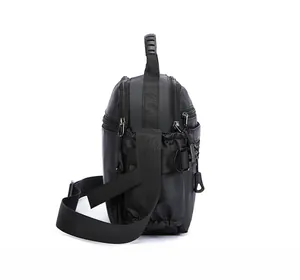 Side view of black nylon shoulder bag showing layered zippers and reinforced handle