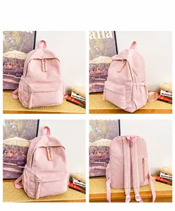 Detail view of pink corduroy backpack featuring multiple zip pockets and adjustable straps