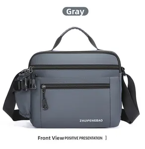 Detailed front view of grey waterproof nylon shoulder bag with multi-zipper pockets