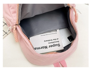 Internal view of pink corduroy backpack showing spacious main compartment with grey lining