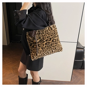 Detail of leopard print faux fur tote bag with plush pom-pom and braided strap