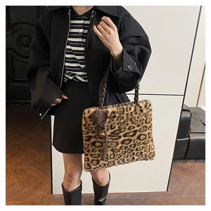 Détail du sac léopard en fausse fourrure avec anses tressées et pompon décoratif