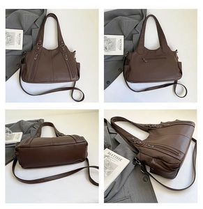Detail view of large dark brown tote bag with pebble leather texture and front zippers