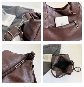 Detail view of the coffee brown lychee leather texture and durable silver hardware buckle