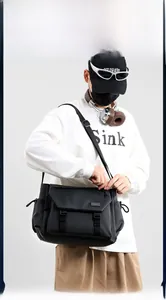 Close-up of black waterproof messenger bag with dual buckle closure and side pockets