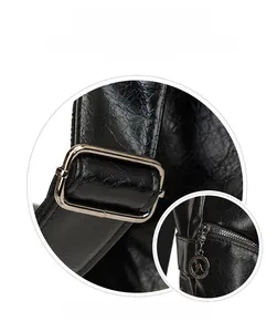 Detail of black litchi leather with silver hardware and logo zipper pull for the bag