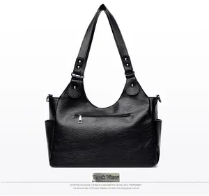 Detailed back view of a black retro leather tote bag with functional zipper and side pockets