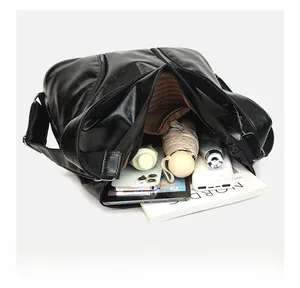 Top view of spacious interior of black leather tote bag showing multi-pocket organization