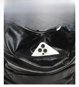 Close-up of black oil wax leather backpack featuring a secure back anti-theft zipper pocket