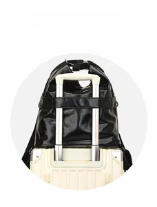 Detail view of black faux leather bag with luggage trolley sleeve for travel convenience