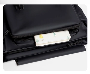 Close-up of waterproof messenger bag front pocket showing storage capacity and zipper