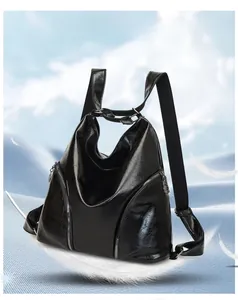 Detail of a soft black PU leather hobo backpack with vertical zippers and woven straps