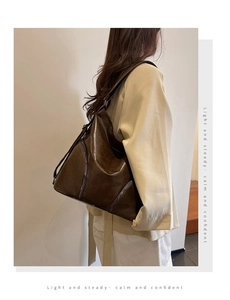 Retro coffee brown hobo bag with zip detail shown in a stylish over-the-shoulder view