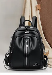 Detail of black lychee grain PU leather backpack with silver zippers and kangaroo logo