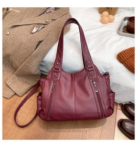 Detail of burgundy large capacity tote bag with lychee texture in an autumn setting