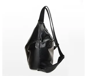 Detail of vintage black textured PU leather shoulder bag with adjustable fabric strap