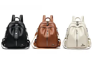 Detailed view of fashionable backpacks in black, yellow, and beige with lychee grain texture