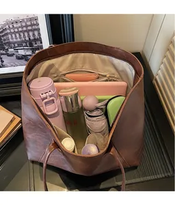 Macro view of the large capacity dark brown tote bag internal compartments and storage