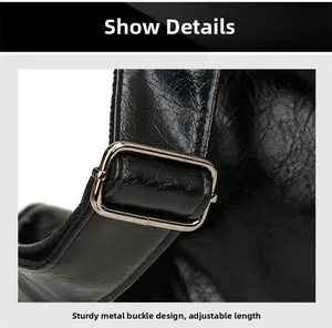 Detail of silver metal buckle on black leather bag with adjustable strap functionality