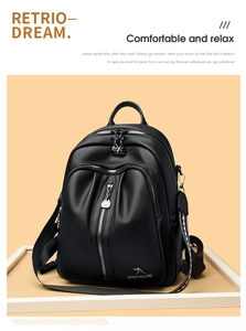 Detail of black lychee grain leather backpack with silver zippers and metal kangaroo logo