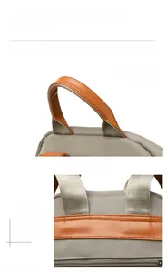 Detail of grey nylon backpack featuring soft leather handles and precision stitching