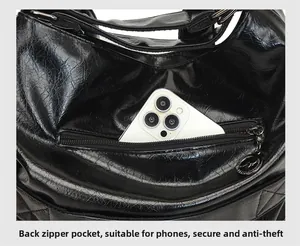 Detail of the back zipper pocket on an oil wax leather bag for anti-theft phone storage