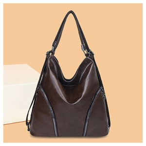 Close-up of retro brown faux leather bag with dual vertical zipper pockets and wax texture