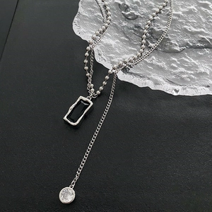 Double-layered silver necklace featuring a black rectangular pendant and zircon charm